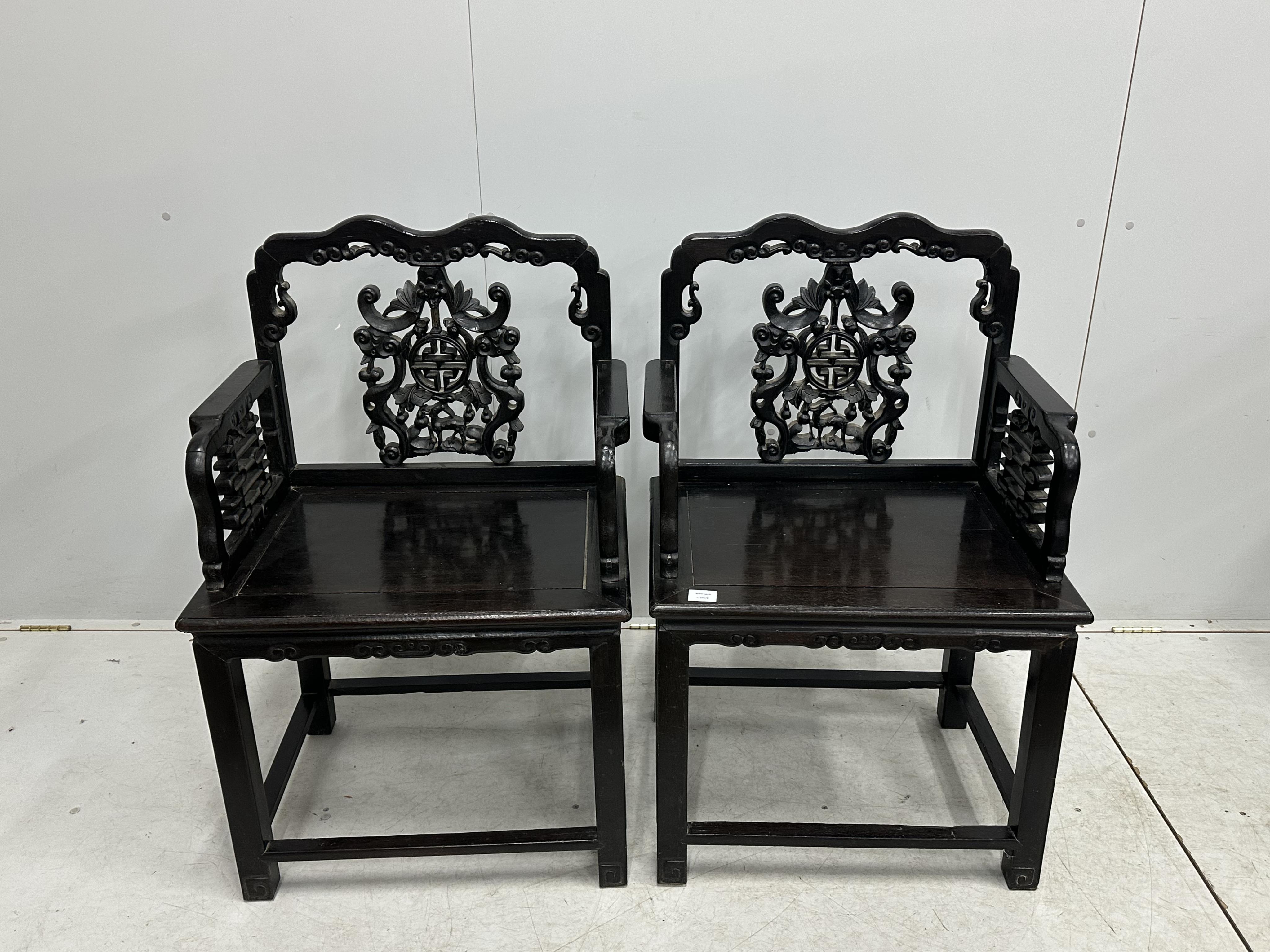 A pair of Chinese hongmu elbow chair, width 64cm, depth 46cm, height 98cm. Condition - fair